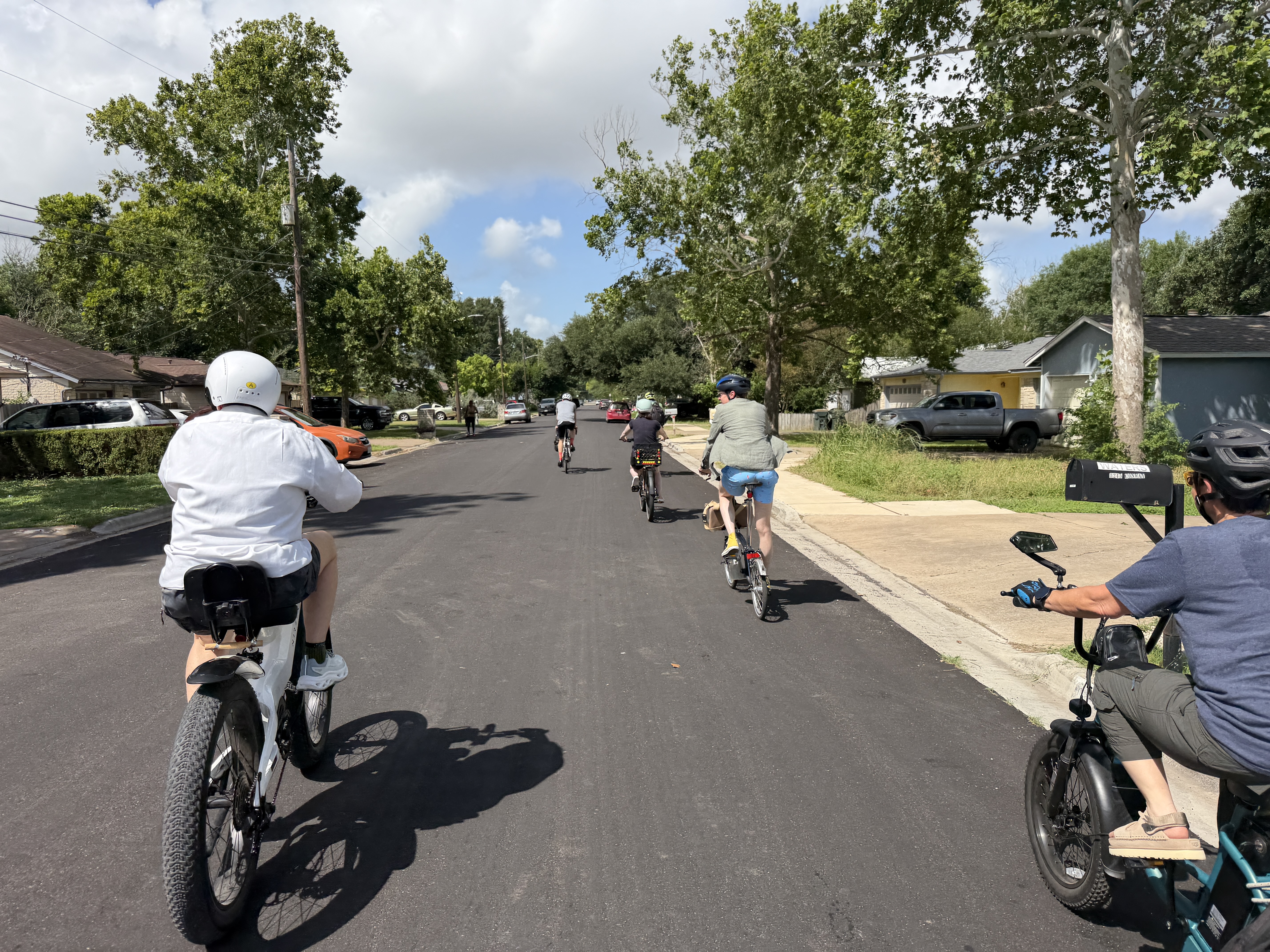 Group riding bikes on a public street.