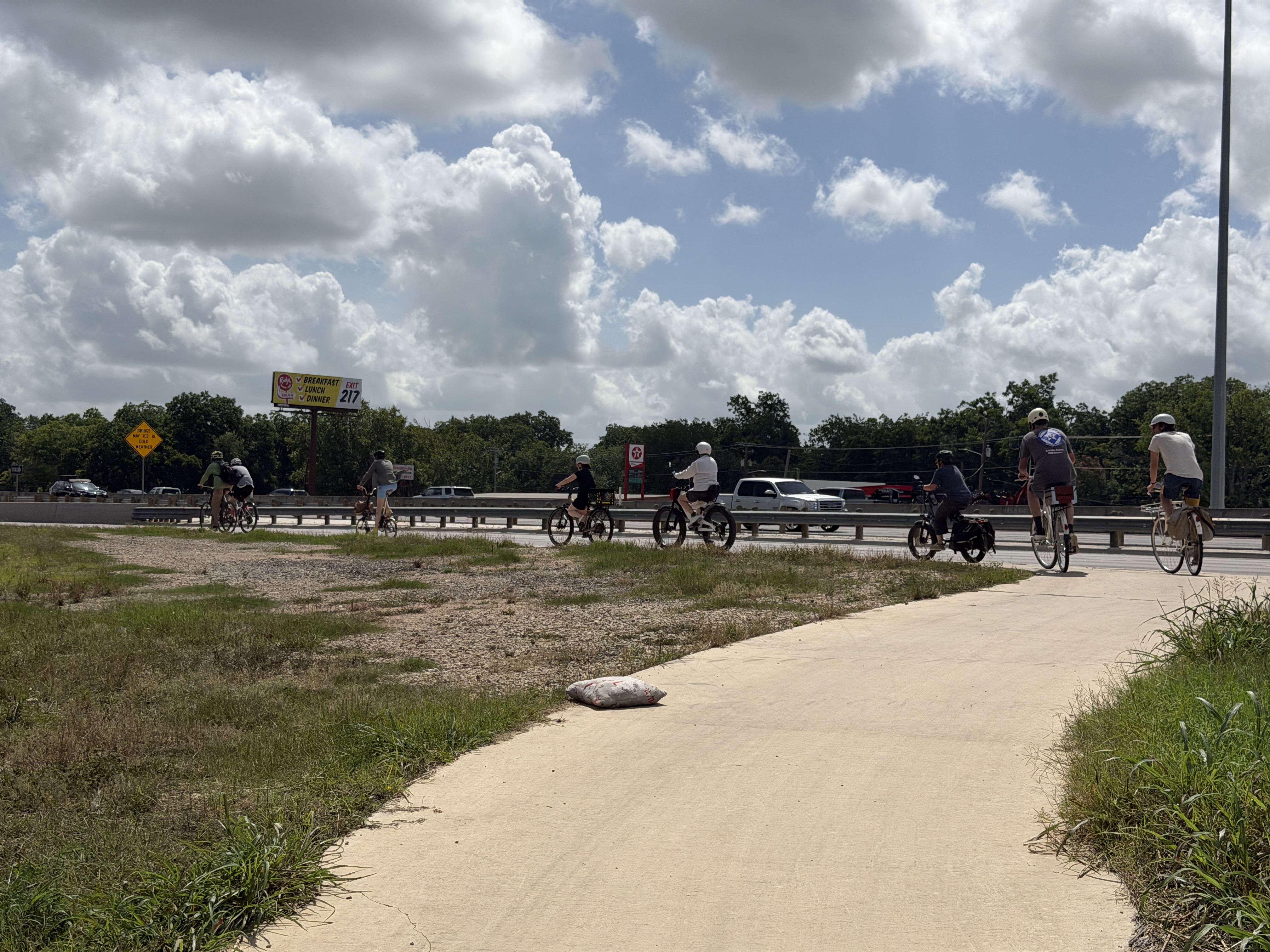 Group riding bikes on a public street.