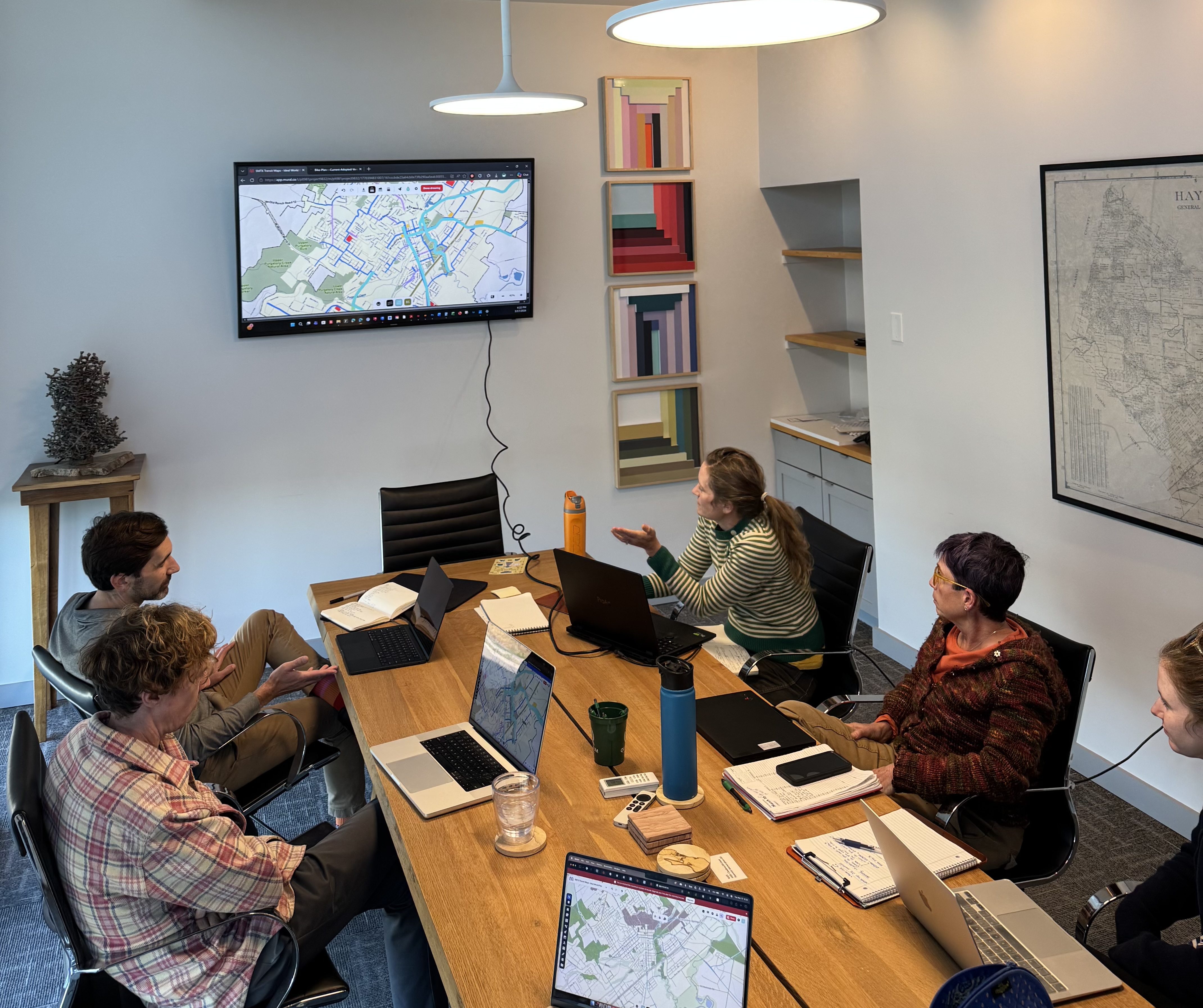 People sitting around a table looking at a map of San Marcos.